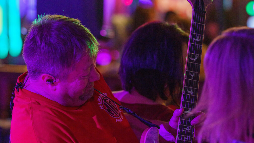 Image of guitarist dancing with lady